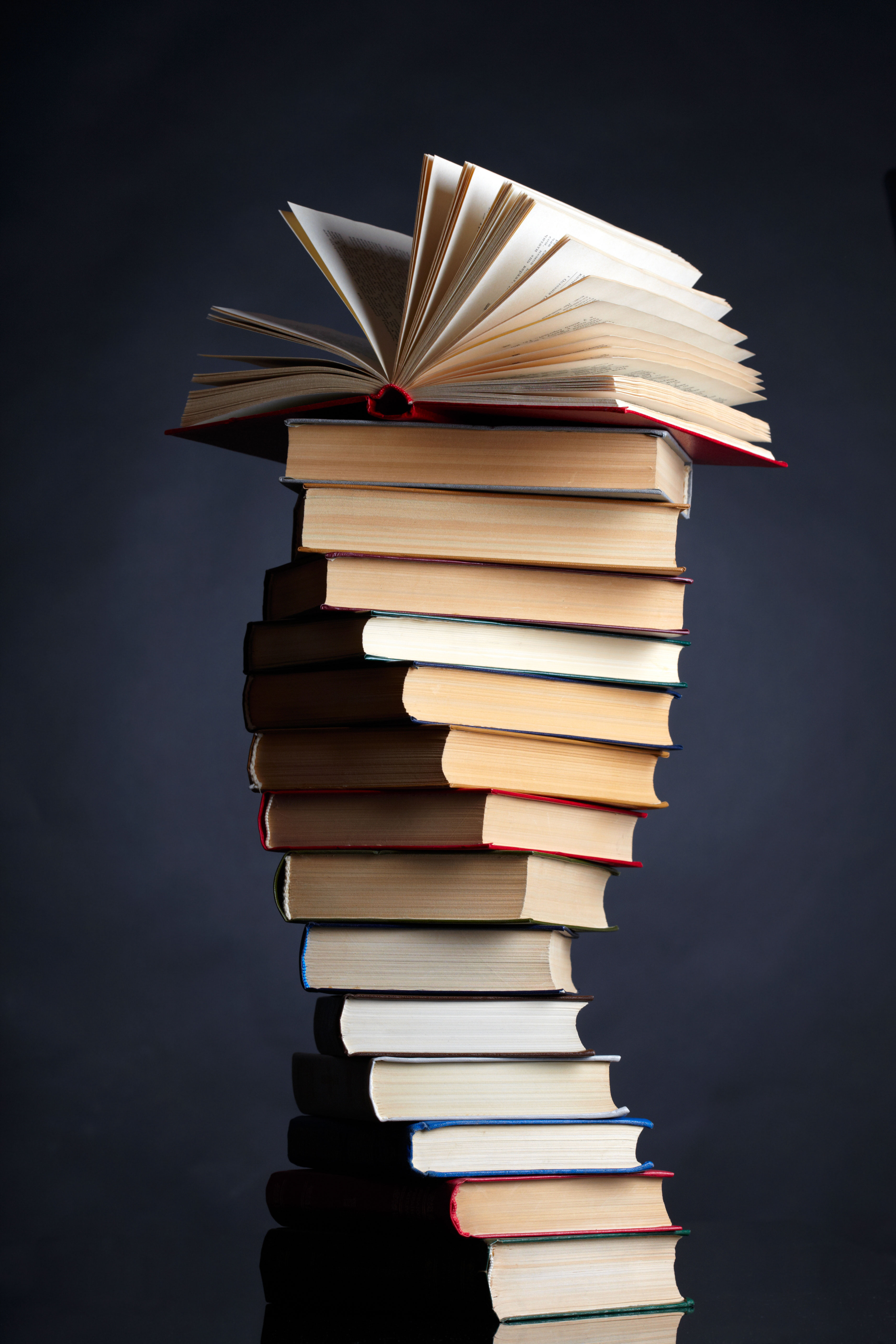 people running with huge stacks of books